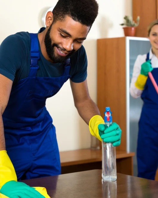 young man cleaning table